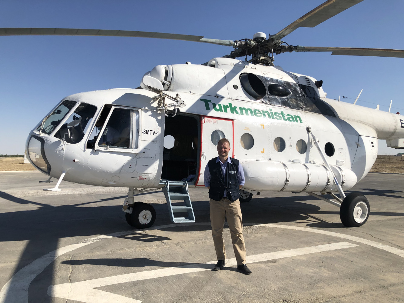 Dr Fielding in front of our helicopter transport to the Turkmenistan border crossing with Afghanistan.